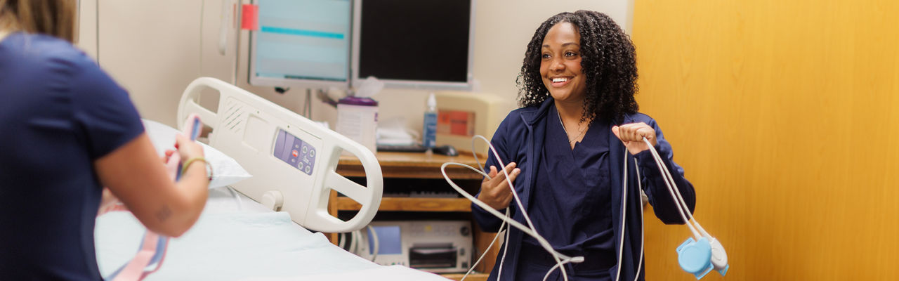 smiling nurse getting a bed ready mobile