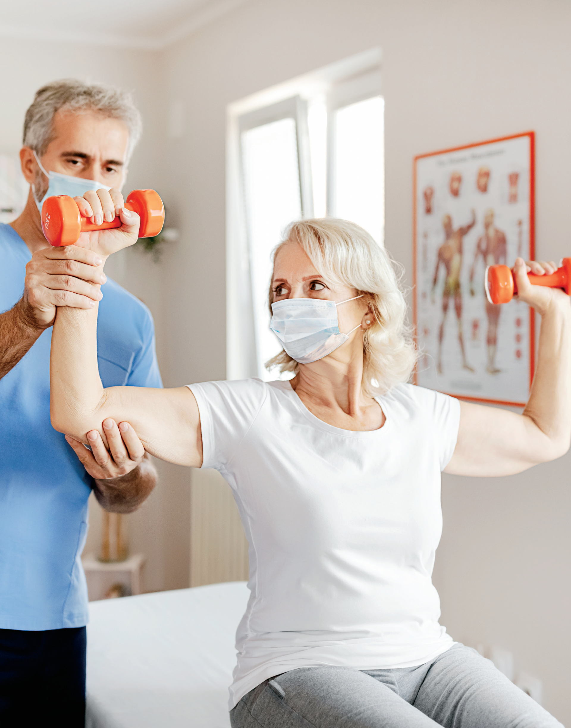 Man assisting a woman with weights
